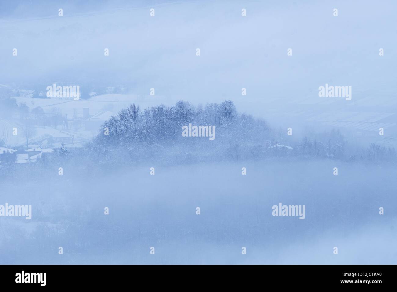 Brianza covered in fresh snow and fog in the early morning, near the town of Brivio, Italy - December 2021. Stock Photo
