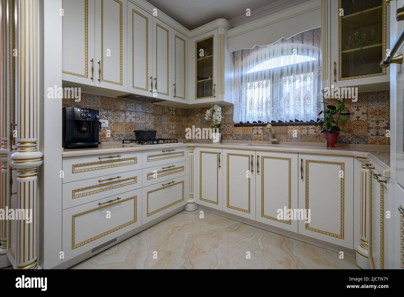 White classic cozy kitchen and dining room in city house Stock Photo