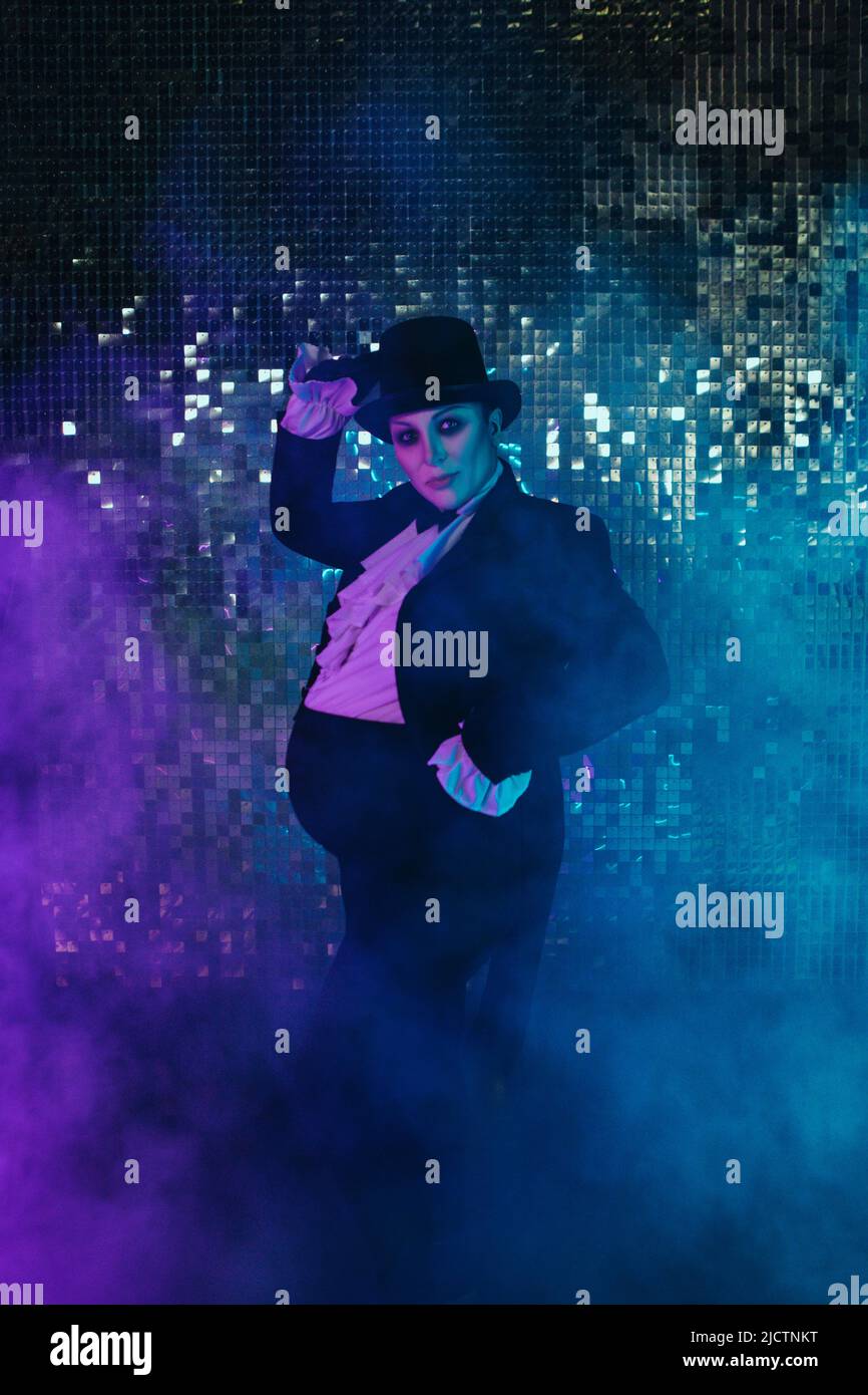 Pregnant girl in the image of a fat man with color lights Stock Photo
