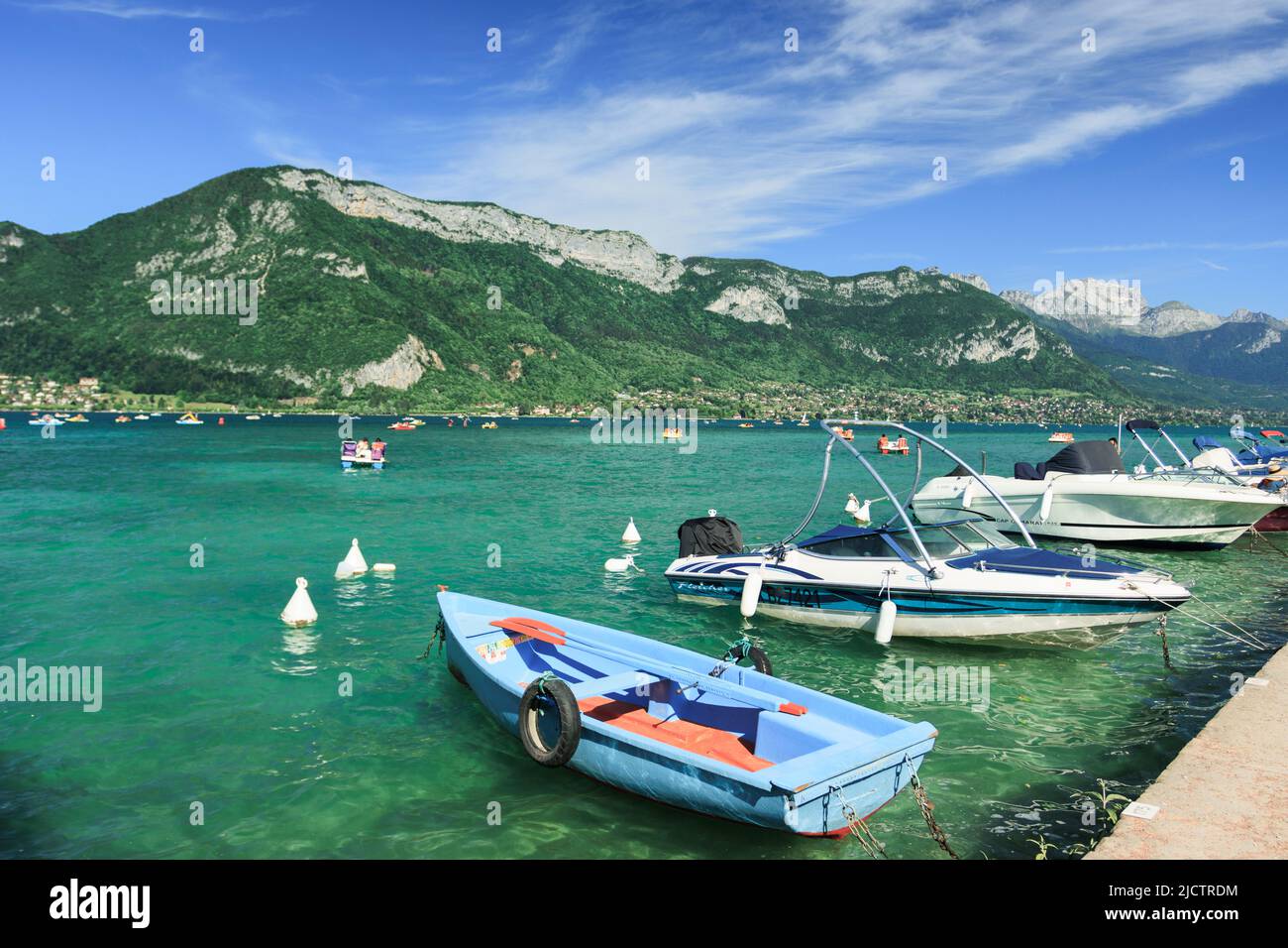 Boats sitting on the shore of Lake Annecy Stock Photo Alamy