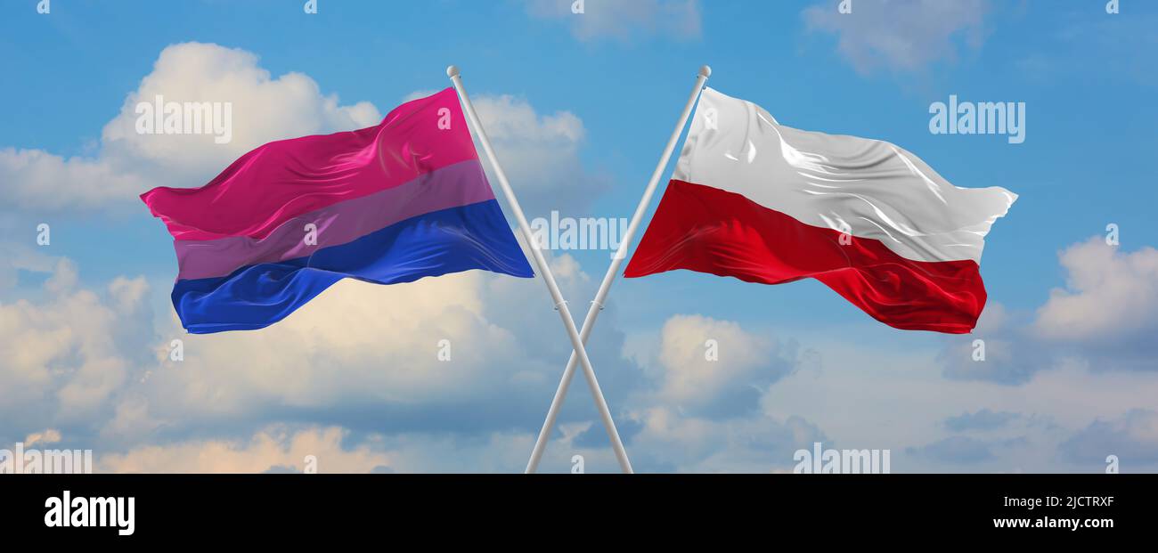 two crossed flags isexuality Pride and Poland waving in wind at cloudy ...