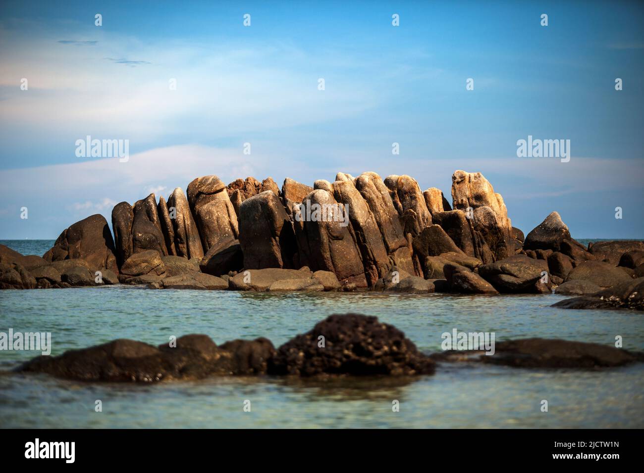 natural rock over blue sea in rayong eastern of thailand Stock Photo