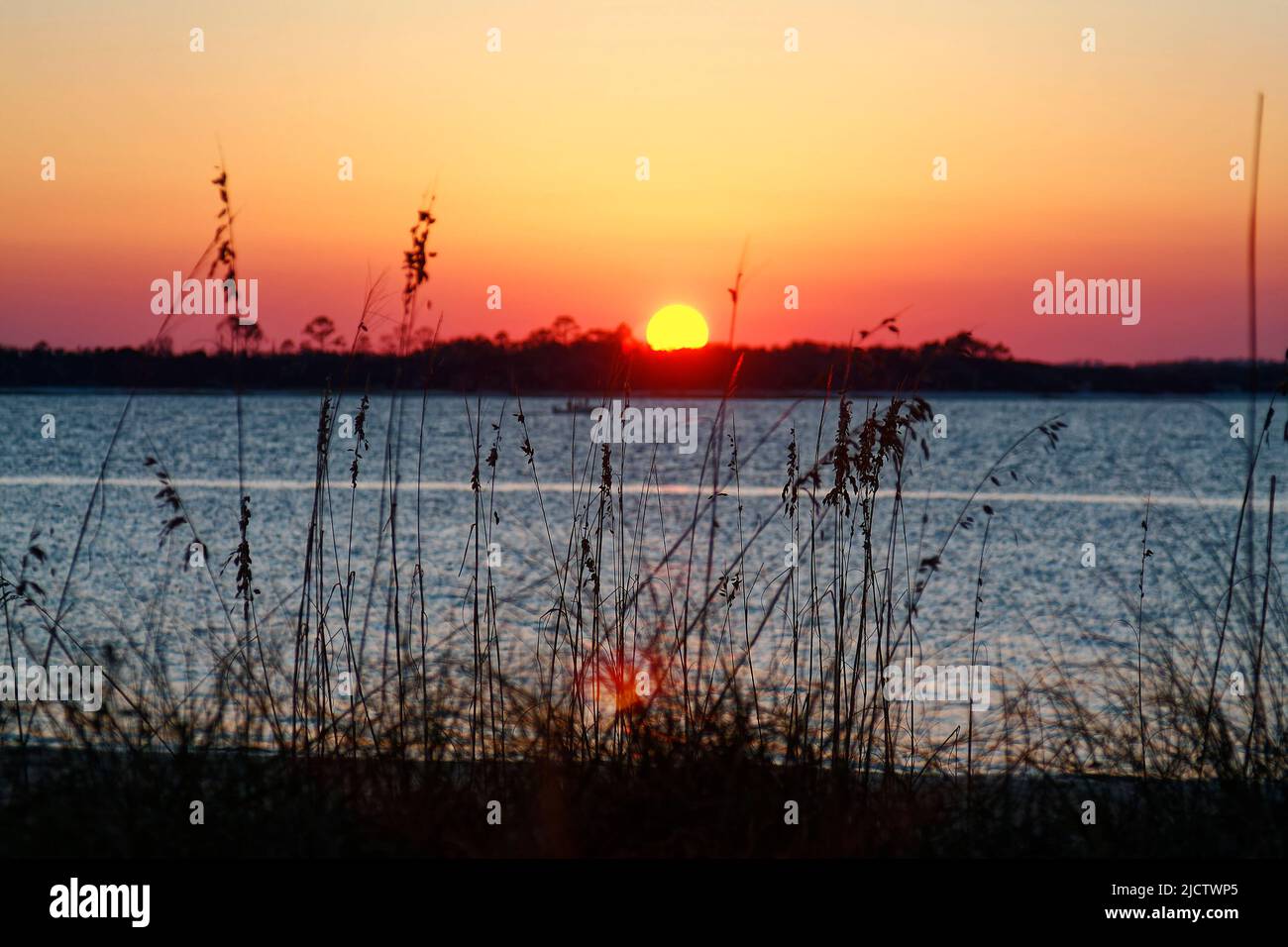 sunset over Amelia River, nature, sky, water, tall grass, Little Tiger Island beyond,  from Fort Clinch State Park, Amelia Island, Fernandina Beach; F Stock Photo