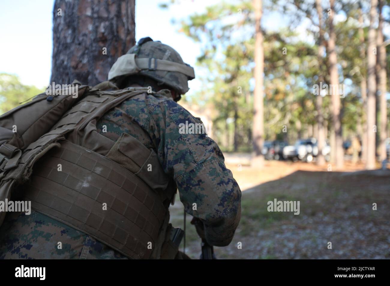 A U.S. Marine with Charlie Company, 1st Battalion, 8th Marine Regiment (1/8), 2D Marine Division, is movinig to another spot to remain providing secur Stock Photo