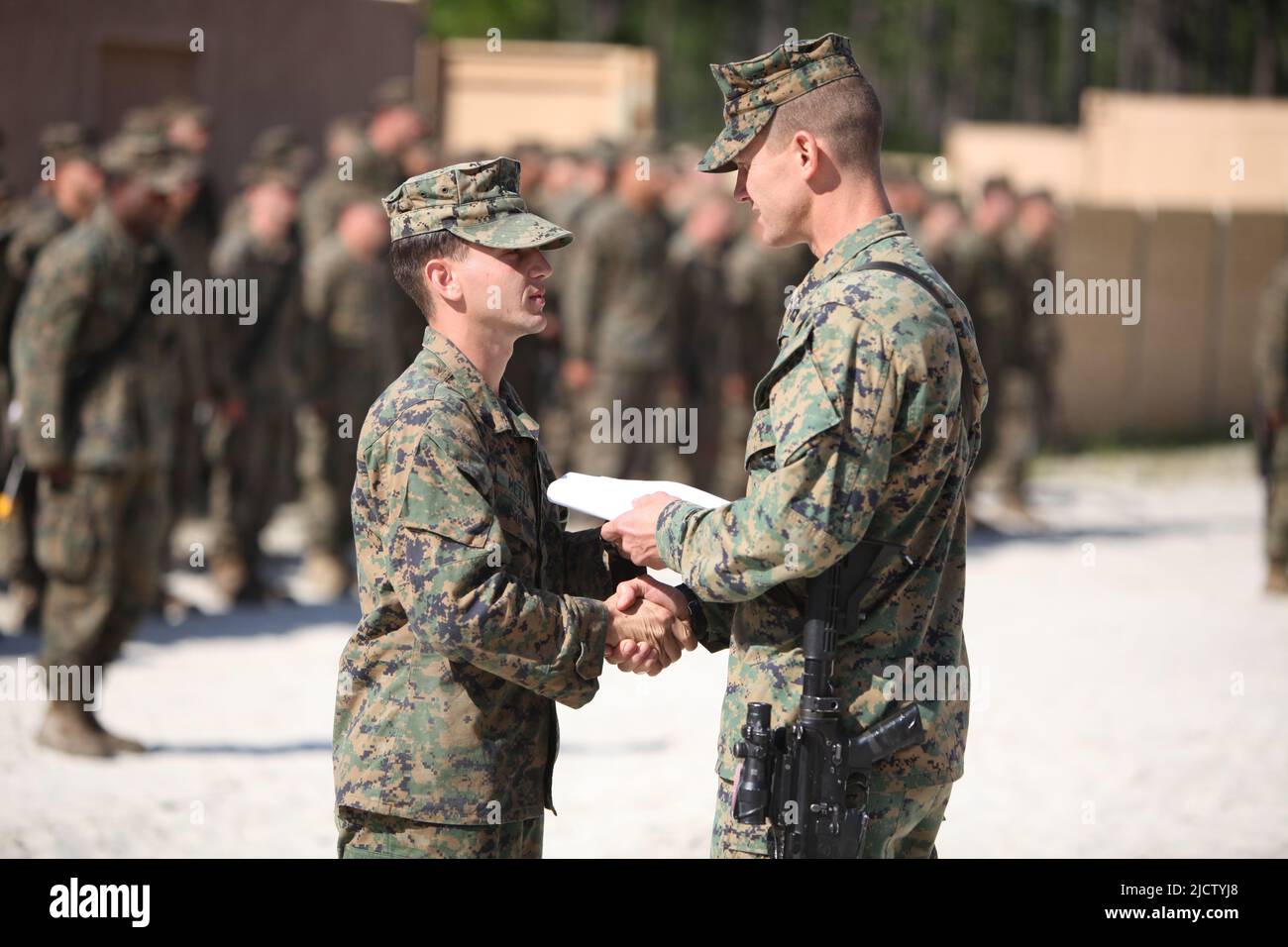 U.S. Marine Corps Corporal Christopher Metts (left) with Charlie Company, 1st Battalion, 8th Marine Regiment (1/8), 2D Marine Division, receives his p Stock Photo