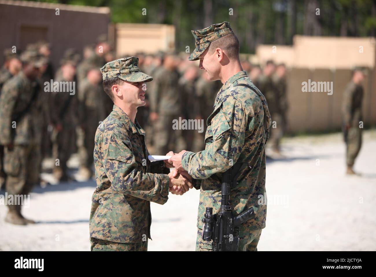 U.S. Marine Corps Corporal Christopher Metts (left) with Charlie Company, 1st Battalion, 8th Marine Regiment (1/8), 2D Marine Division, receives his p Stock Photo