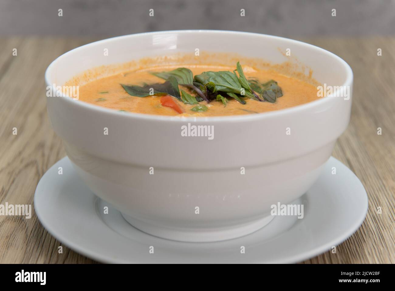 Spicy Panang Curry with decorative garnishment served in a bowl and ready to eat. Stock Photo