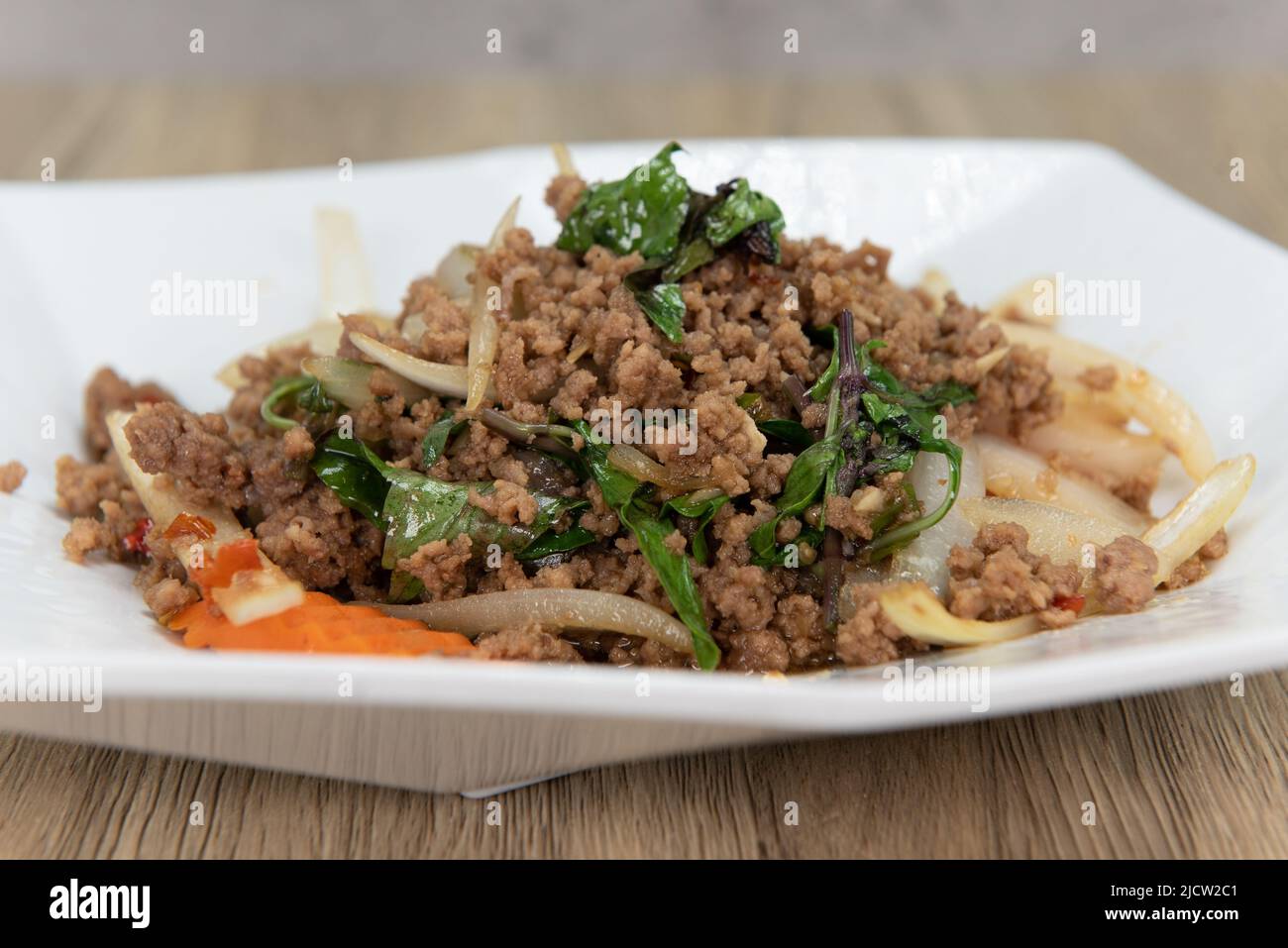 Tasty mint leaves stir fry with decorative garnishment served on a plate and ready to eat. Stock Photo