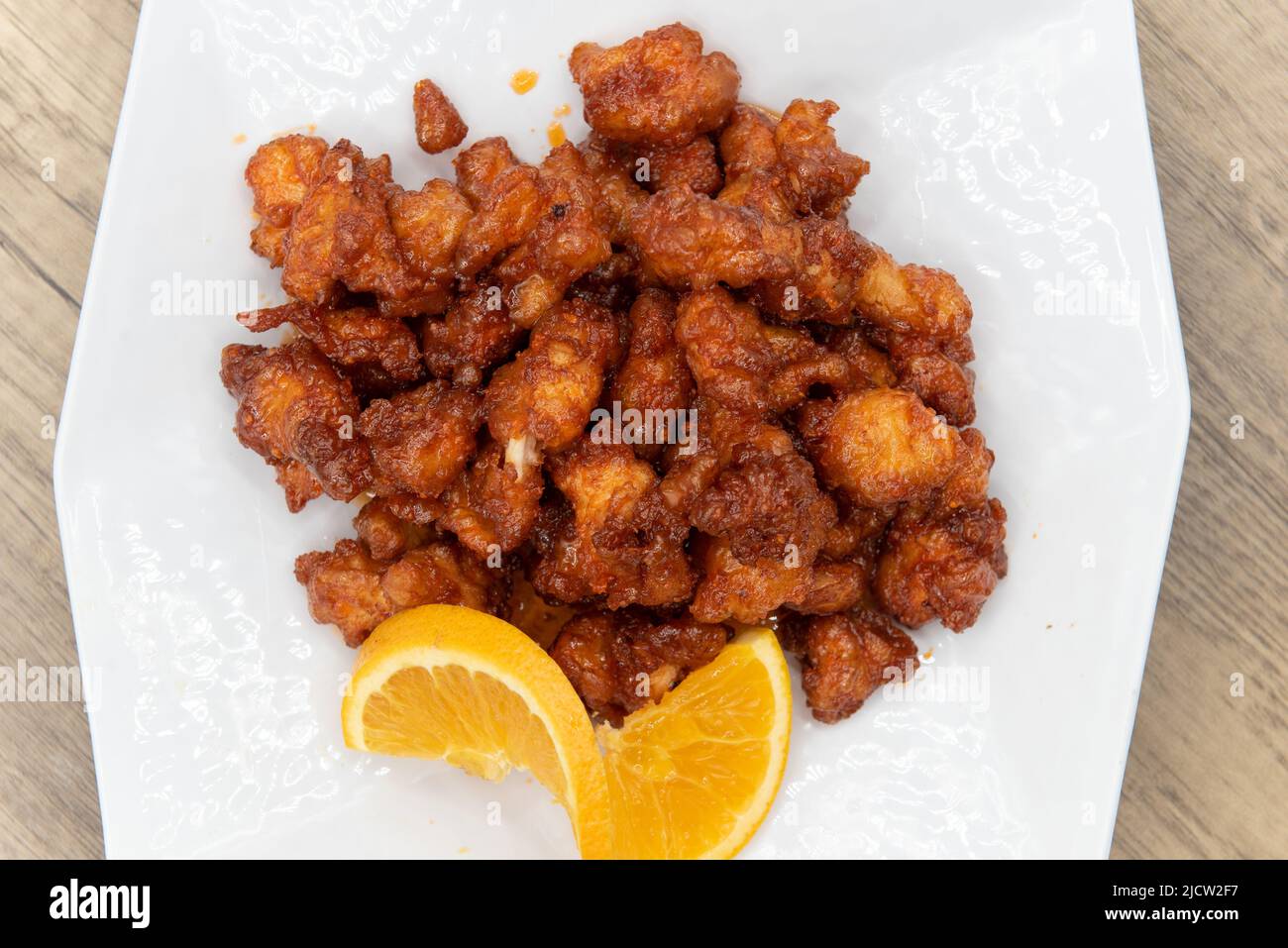 Overhead view of tangy orange chicken piled high with crispy crunchy pieces and ready to eat. Stock Photo