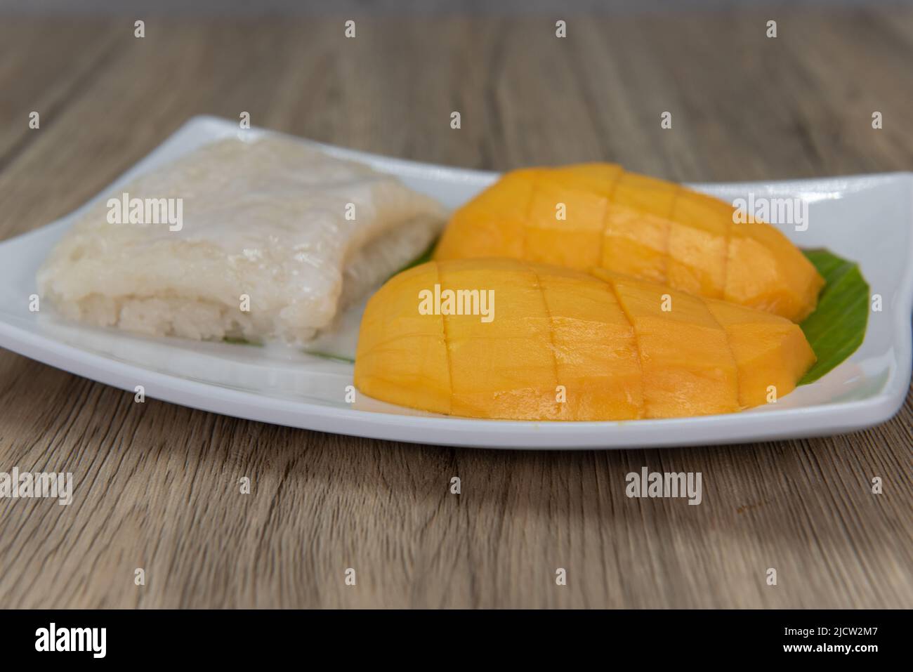 Tempting combination plate of sliced mango served with sweet sticky rice. Stock Photo