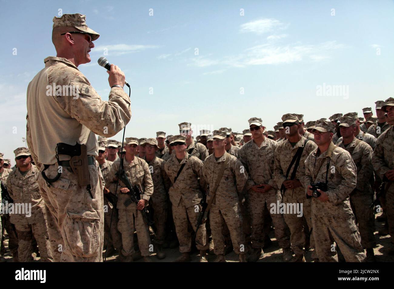 US Marines give a speech to fellow Marines congratulating them on a job well done while deployed to Helmond Province, Afghanistan. Stock Photo