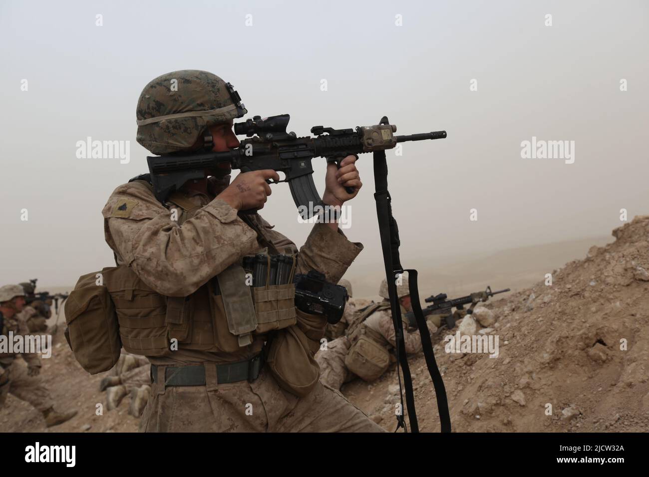 US Marines with 1st Battalion, 8th Marine Regiment return fire from covered positions from enemy machine guns, Kajaki, Afghanistan. Stock Photo