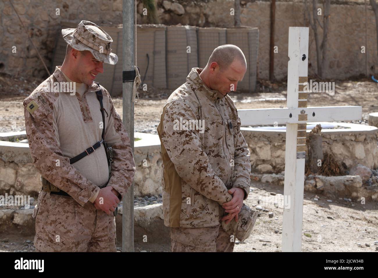 US Marines pay their respects to a fallen comrade's memorial while forward deployed to Kajaki, Helmond Province Afghanistan. Stock Photo