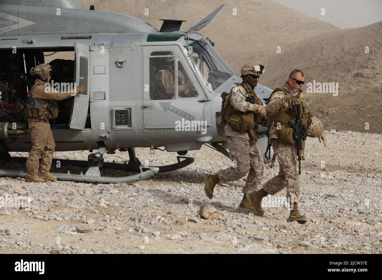 U.S. Marine Corps Sgt. Maj. James A. Deets, Sgt. Maj. of Regimental Combat Team 6 (RCT 6), prepares to debark a helicopter after landing in Kajaki, Af Stock Photo