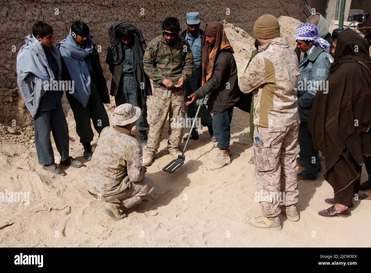 U.S. Marines with the Police Advisory Team 2 (PAT 2) (center), 1st Battalion, 8th Marine Regiment, Regimental Combat Team 6, watch an Afghan Uniformed Stock Photo