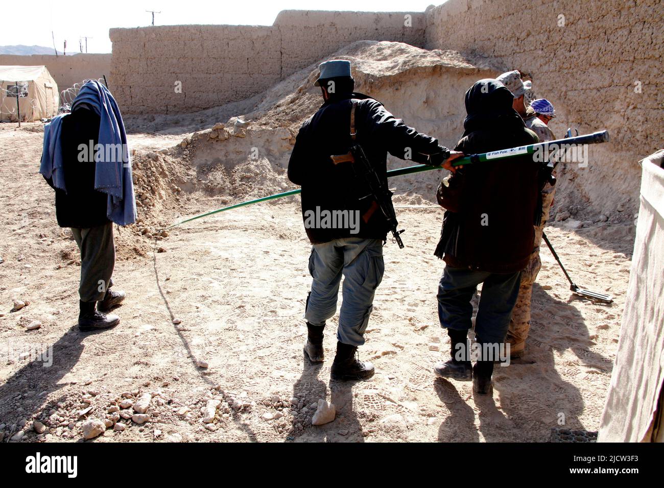 A U.S. Marine with the Police Advisory Team 2 (PAT 2) (left), 1st Battalion, 8th Marine Regiment, Regimental Combat Team 6, shows an Afghan Uniformed Stock Photo