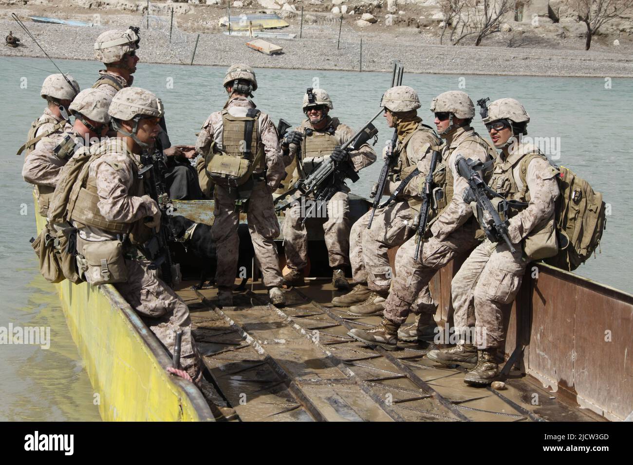 U.S. Marines with 1st Battalion, 8th Marine Regiment (1/8), Regimental Combat Team 6, cross the Helmond River on an Afghan's barge during a security p Stock Photo