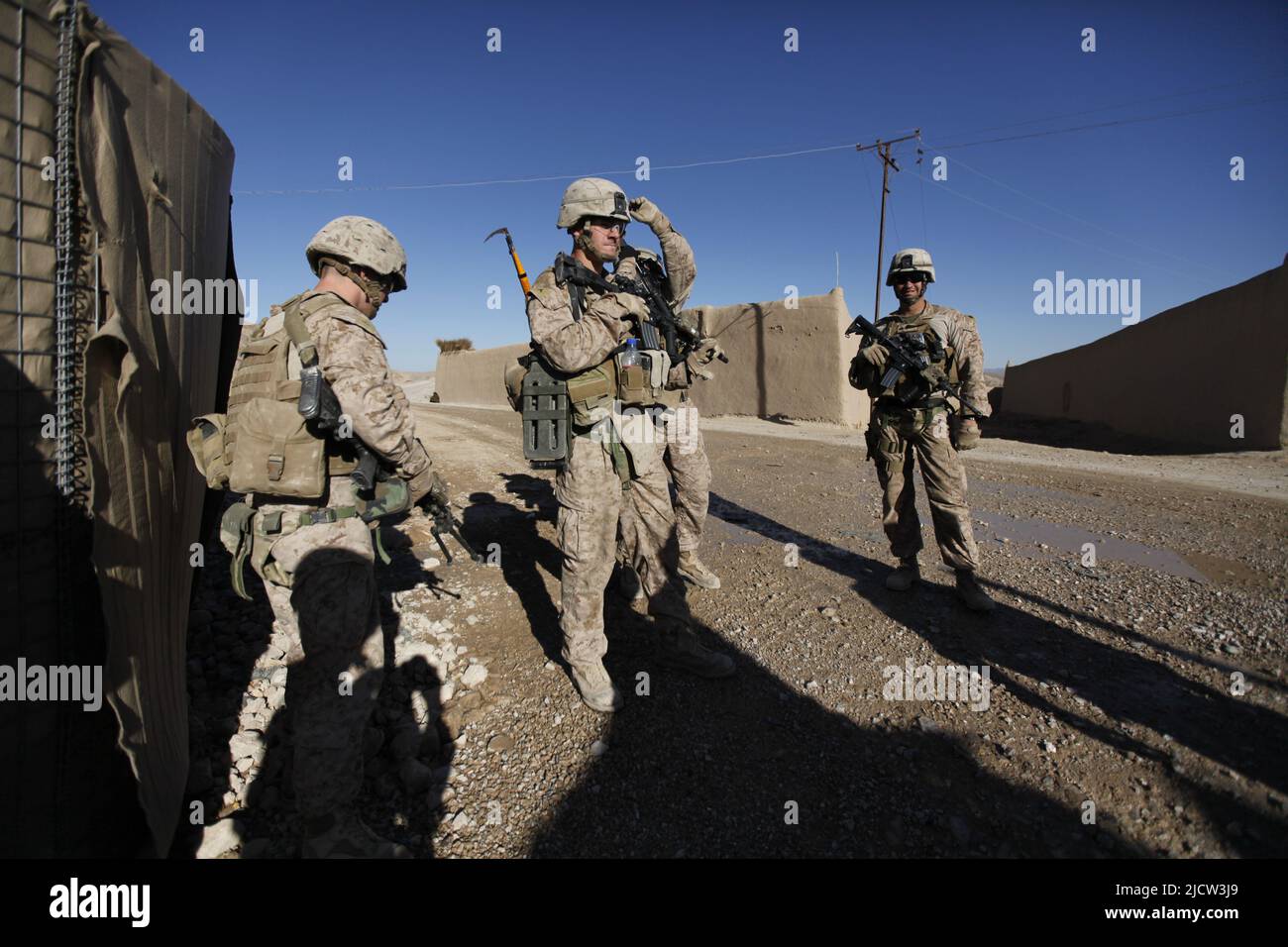 U.S. Marines with Weapons Company, 1st Battalion, 8th Marine Regiment (1/8), Regimental Combat Team 6, leave friendly lines to patrol north on route 6 Stock Photo