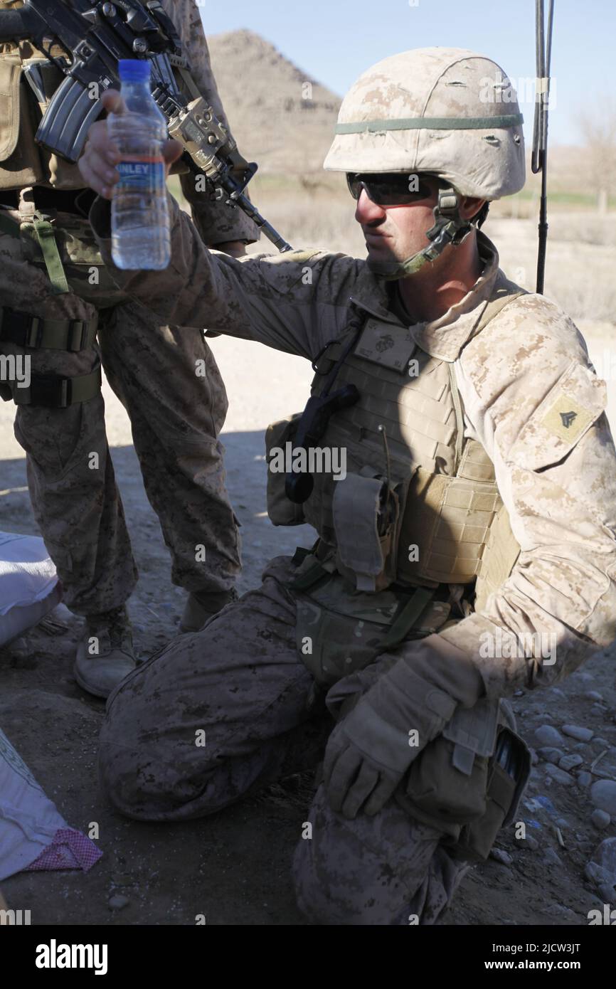 A U.S. Marine with Weapons Company, 1st Battalion, 8th Marine Regiment (1/8), Regimental Combat Team 6, tests suspected illegal fertilizer while patro Stock Photo