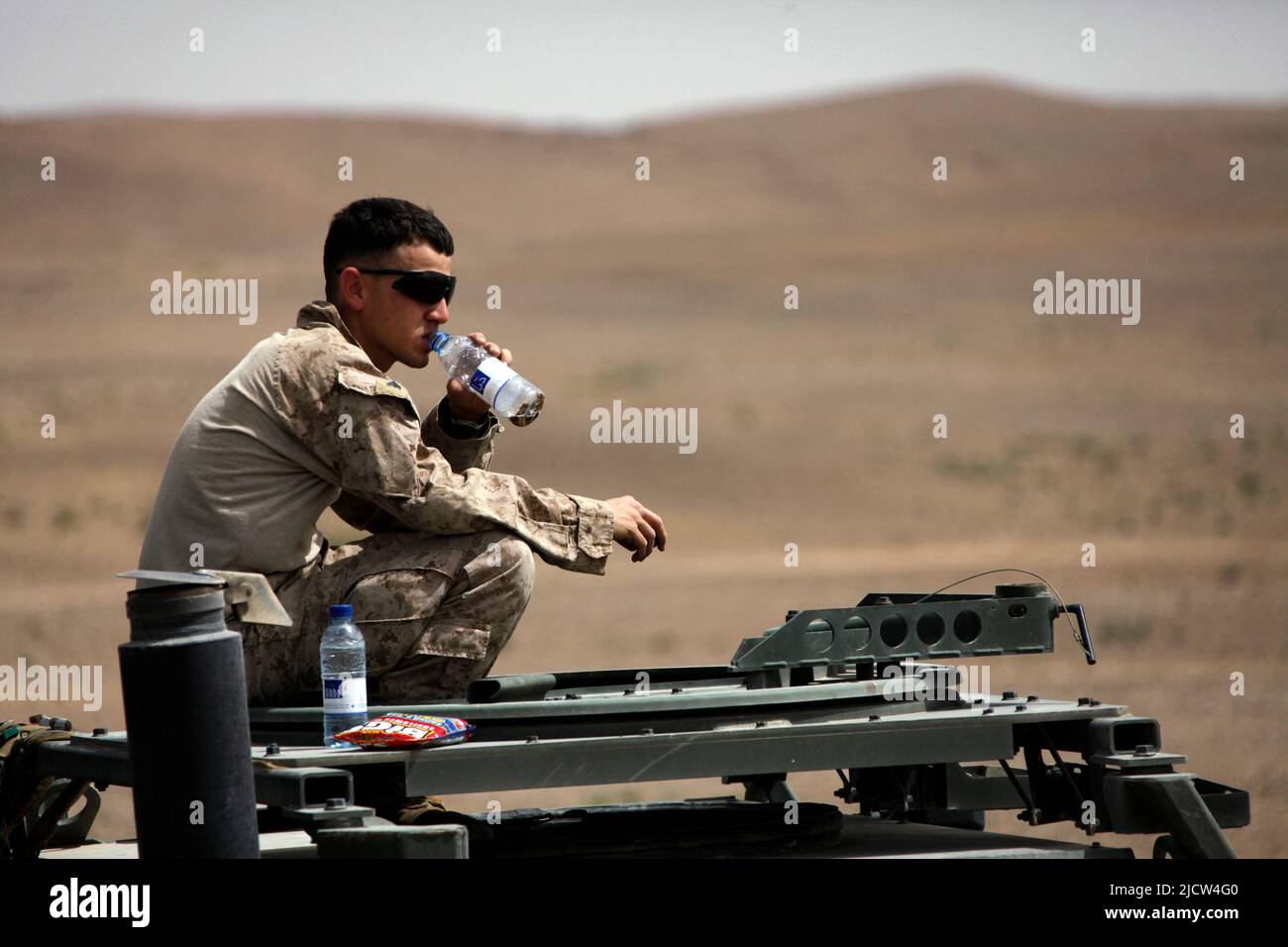 A U.S. Marine with 1st Battalion, 8th Marine Regiment (1/8), Regimental Combat Team 6, drinks water to stay hydrated outside Camp Delaram II, Nimroz p Stock Photo