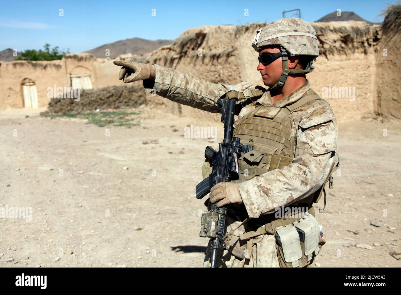 U.S. Marine Corps Lance Cpl. Christopher Mount with 1st Battalion, 8th Marine Regiment (1/8), Regimental Combat Team 6, points out an enemy fighting p Stock Photo
