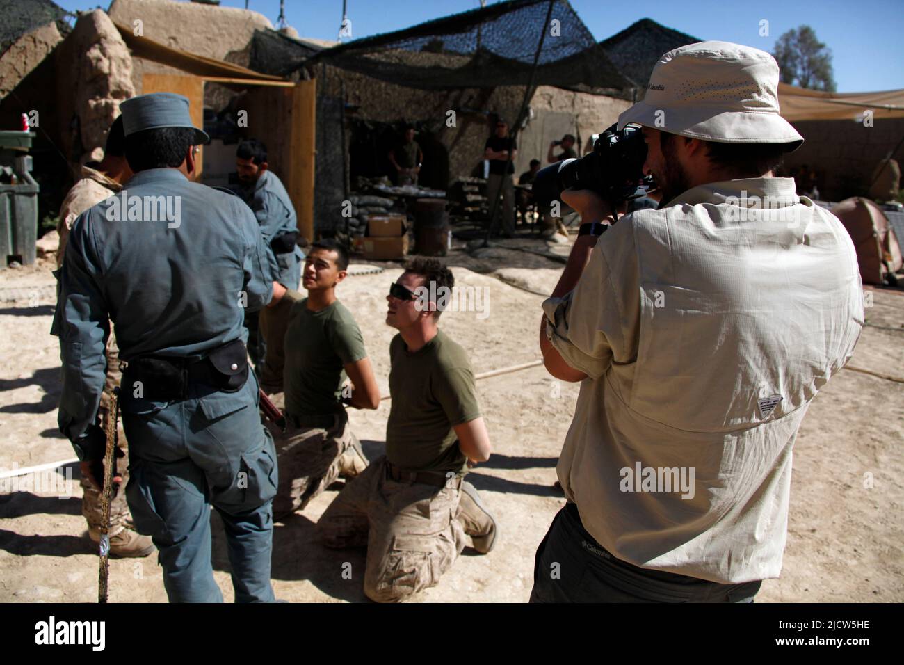 Ben Foley, right, cameraman, with Al Jazeera English News Channel films local Afghan Uniformed Police training as U.S. Marines with Police Advisory Te Stock Photo