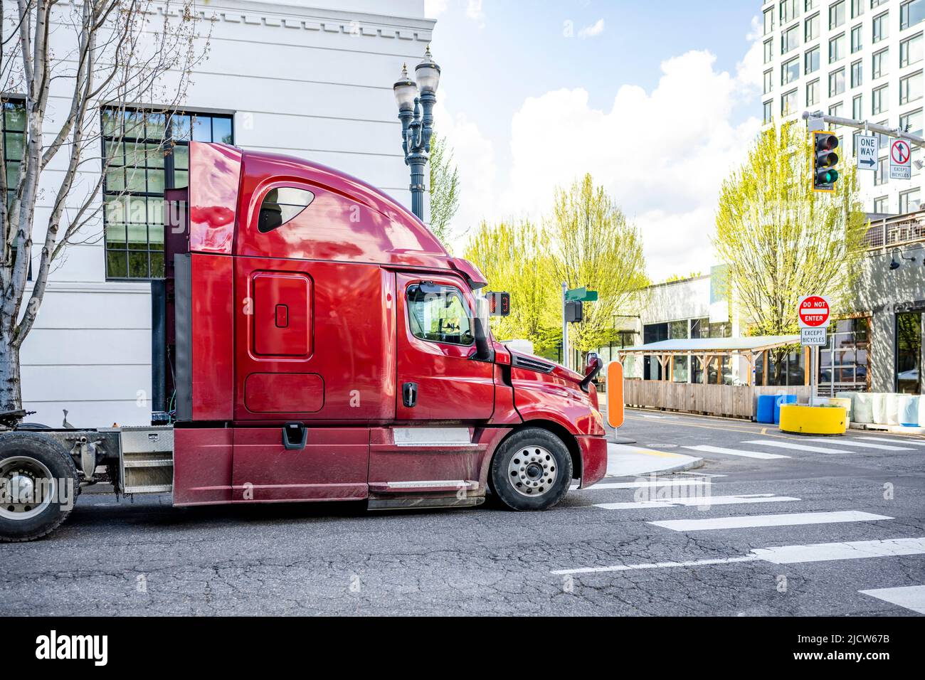Shiny burgundy big rig industrial grade semi truck tractor