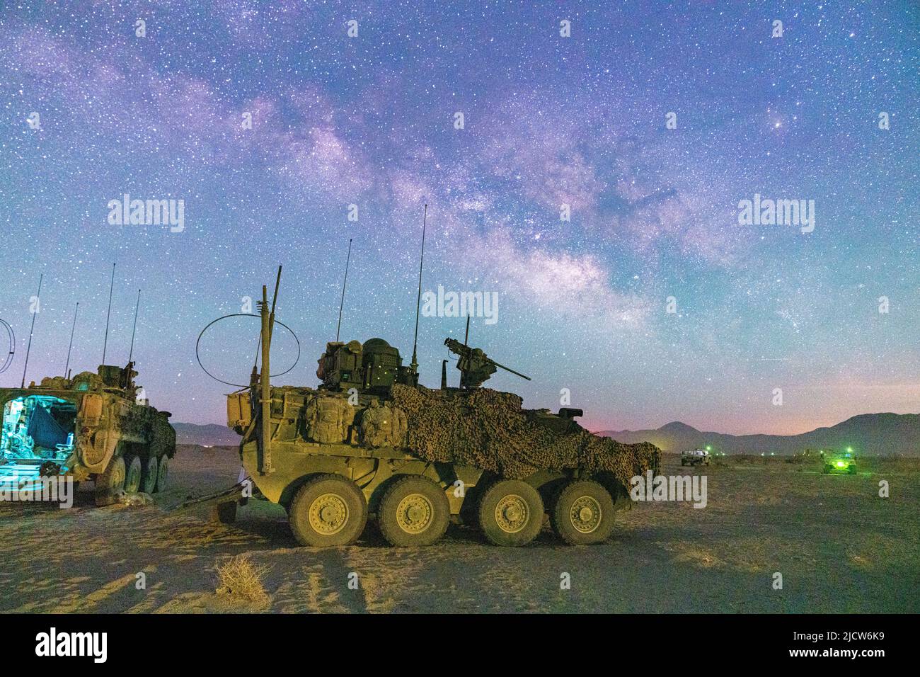 A U.S. Army Stryker assigned to Col. Kevin Bradley, commander of 3d Cavalry Regiment, is parked at a remote location of the National Training Center during a moonless, open sky where the milky way was visible May 24, 2022. Additionally, unmanned aircraft circled the vicinity to monitor for threats and intelligence from the sky. (U.S. Army photo by Staff Sgt. Christopher Stewart) Stock Photo
