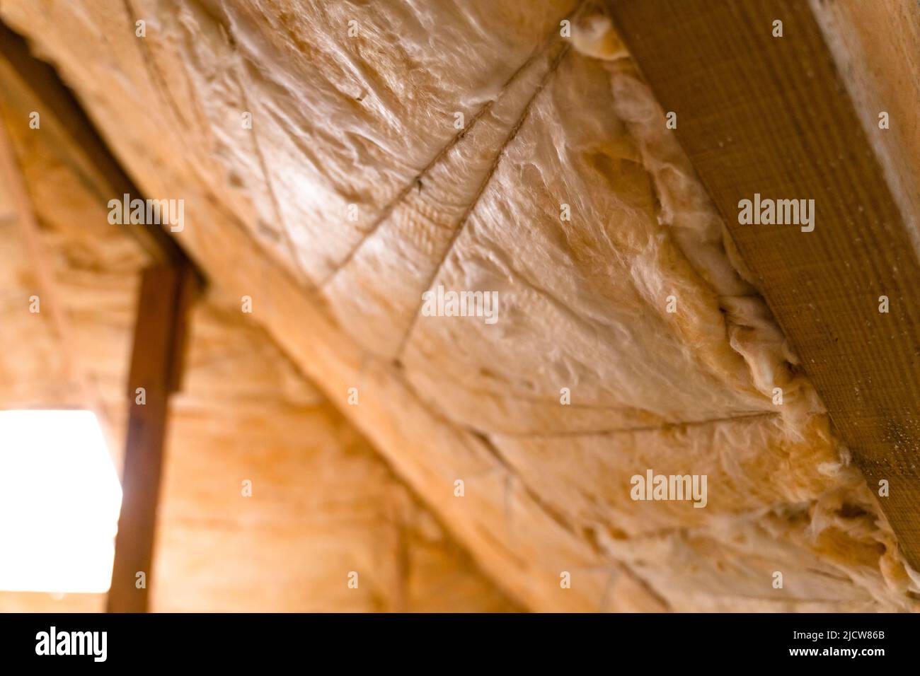 The roof is insulated with yellow glass wool. Insulation hemming with ...