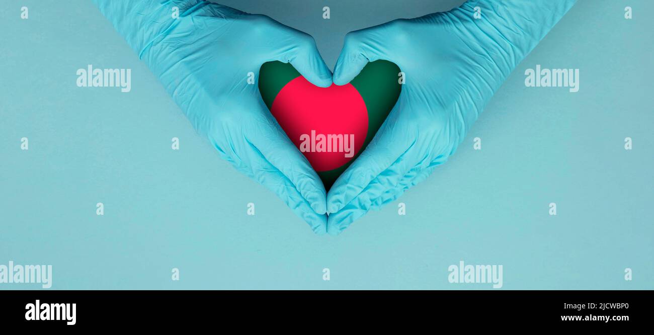 Doctors hands wearing blue surgical gloves making hear shape symbol