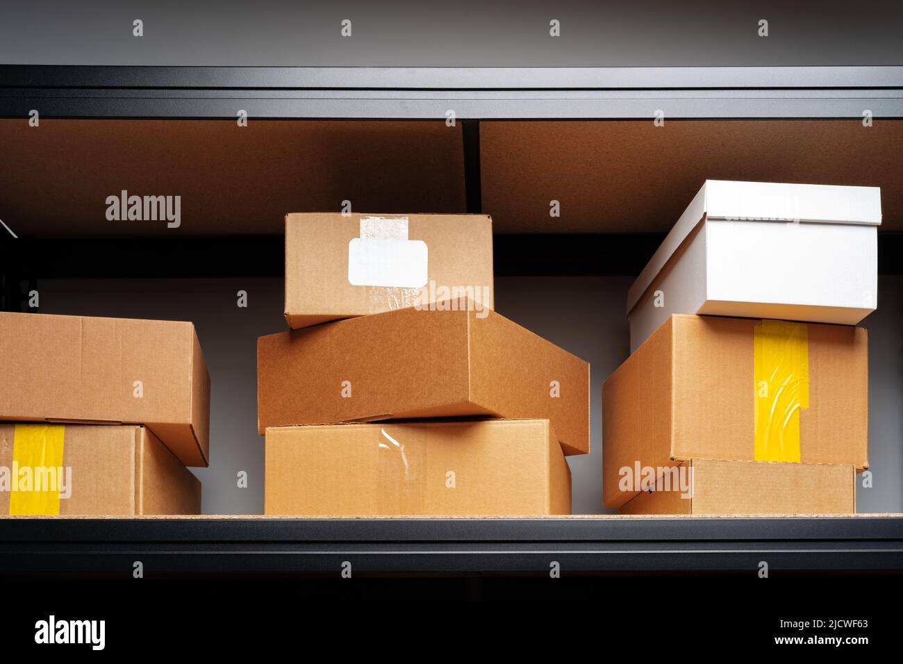 Rows of shelves with cardboard boxes in modern warehouse Stock Photo ...
