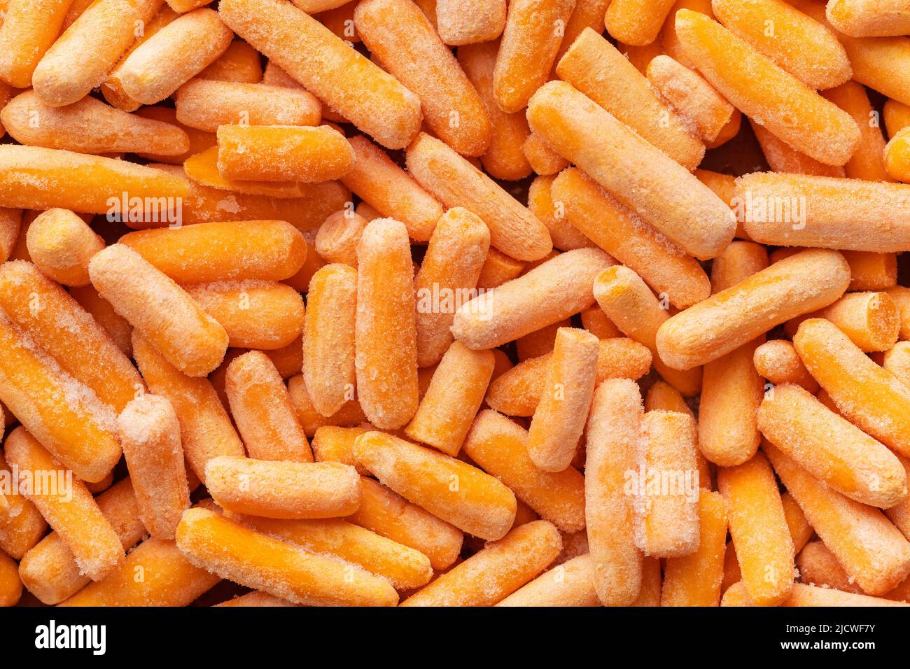 Frozen baby carrot vegetable. Mini orange carrots. Top view. Stock Photo