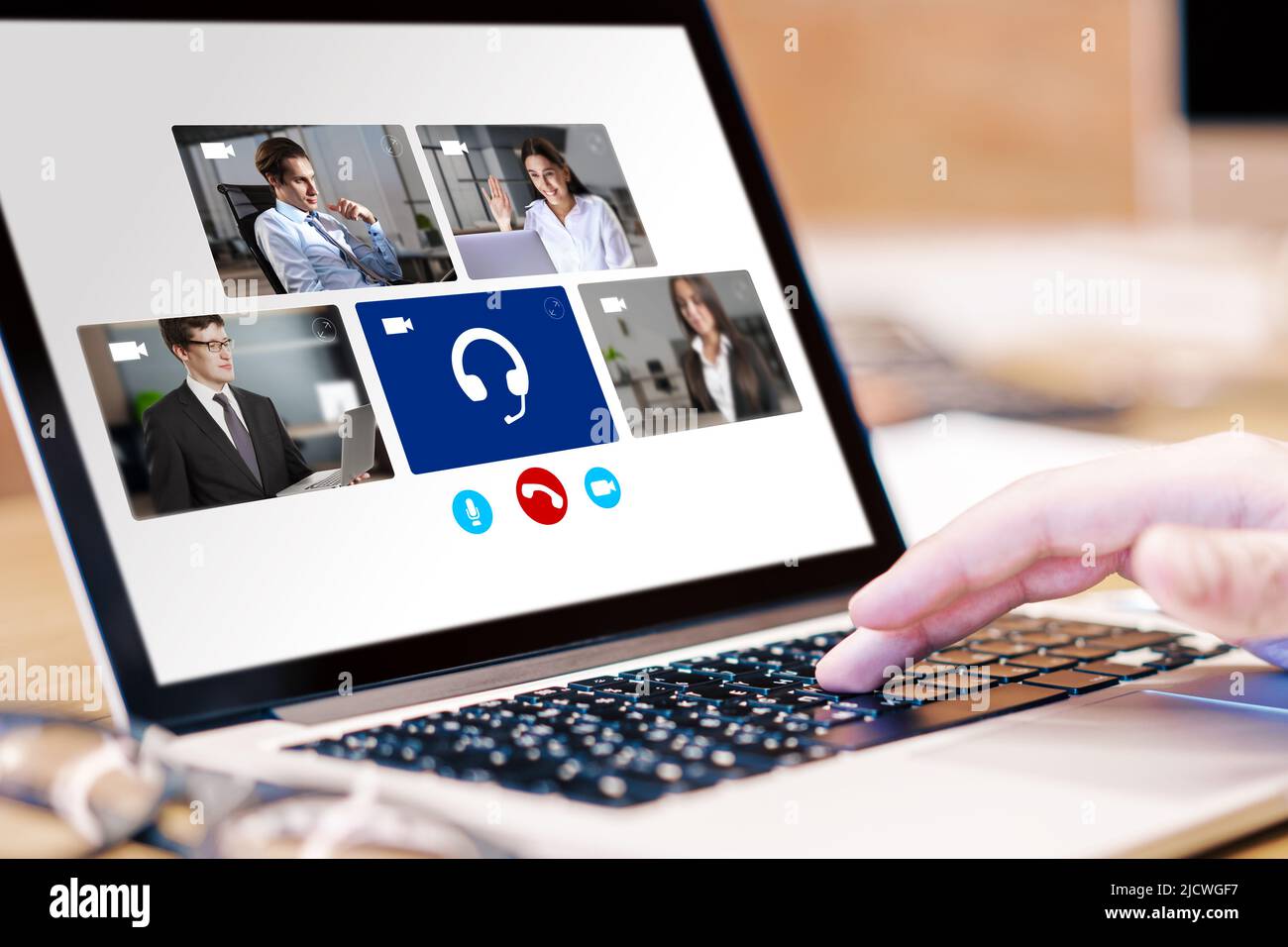 Concept of online video communication with man finger typing on laptop keyboard and group of