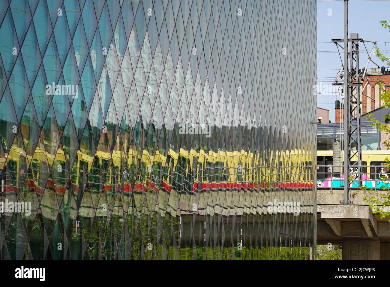 Reflection of a moving Berlin suburban train in the glass facade of the Futurium Berlin, Germany, 29.4.22 Stock Photo
