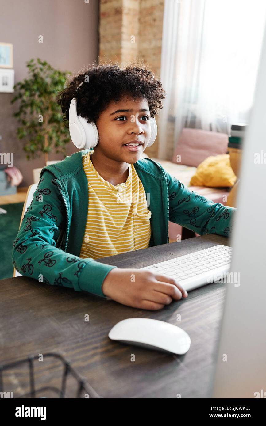 Little Boy Playing Car Game On Computer At Home Stock Photo