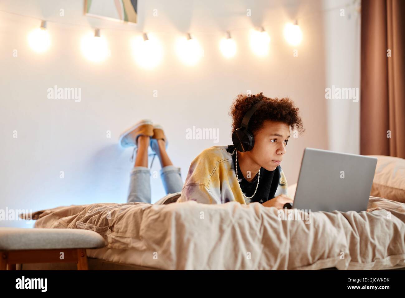 Teen boy lying laptop hi-res stock photography and images - Alamy