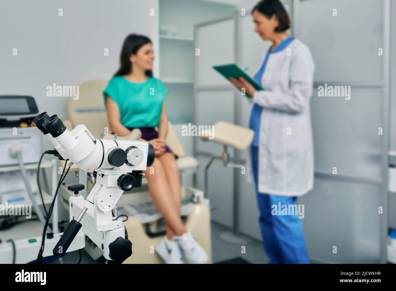 Woman patient sitting in gynecological chair during consultation with her gynecologist in medical clinic. Gynecology Stock Photo