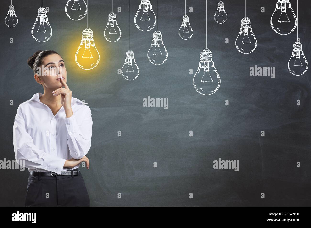 Creativity and idea concept with young pensive woman in white shirt ...