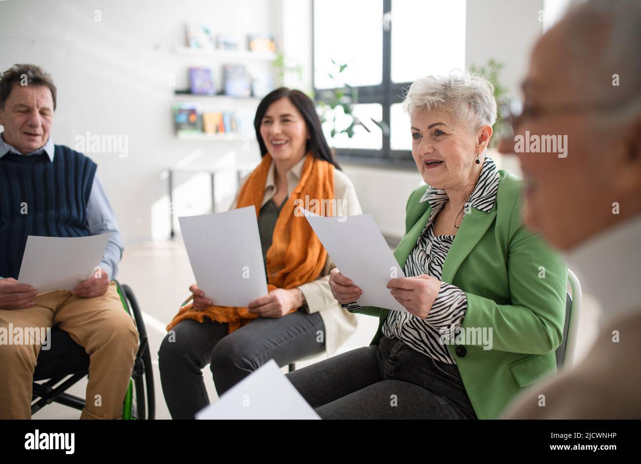 Group of seniors with singing together at choir rehearsal. Stock Photo