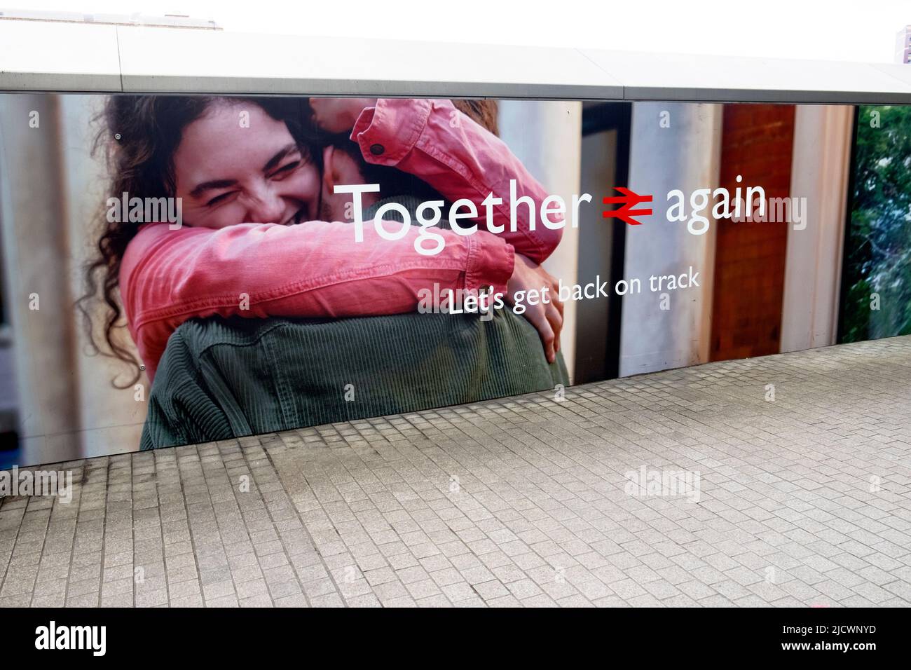 British Rail post covid 19 lockdown advert  2022 'Together again' Let's get back on track' people hugging  Paddington Station London England UK Stock Photo