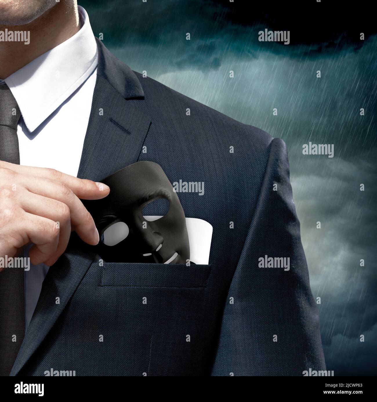 Businessman taking out a mask in his pocket. Hypocrisy. Mask symbolizing good and evil. Stock Photo