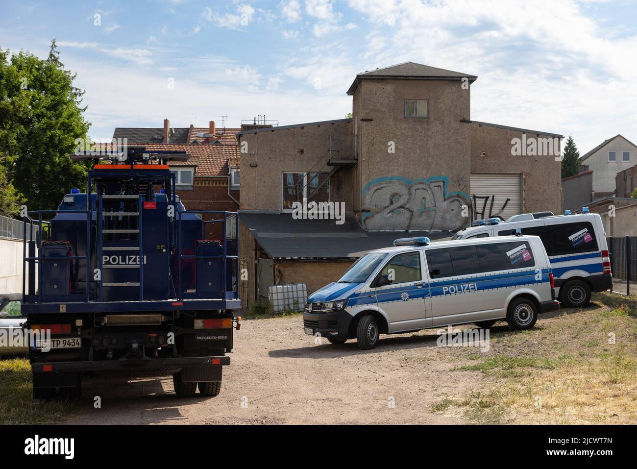 Gotha, Germany. 16th June, 2022. Police cars drive off a factory site after a raid. With a large contingent, police searched a total of 26 residential and business premises in Thuringia, Schleswig-Holstein and Berlin on Thursday. According to the Thuringian State Criminal Police Office (TLKA), more than 500 officers from Thuringia as well as special forces from other federal states were deployed. Suspicion exists because of the trade with narcotics in connection with money laundering as well as offence against the weapon law. Credit: Michael Reichel/dpa-Zentralbild/dpa/Alamy Live News Stock Photo