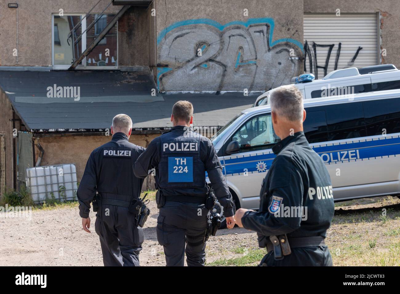 Gotha, Germany. 16th June, 2022. Police officers search a factory building during a raid. With a large contingent, police searched a total of 26 residential and business premises in Thuringia, Schleswig-Holstein and Berlin on Thursday. According to the Thuringian State Criminal Police Office (TLKA), more than 500 officers from Thuringia and special forces from other federal states were deployed. Suspicion exists because of the trade with narcotics in connection with money laundering as well as offence against the weapon law. Credit: Michael Reichel/dpa-Zentralbild/dpa/Alamy Live News Stock Photo