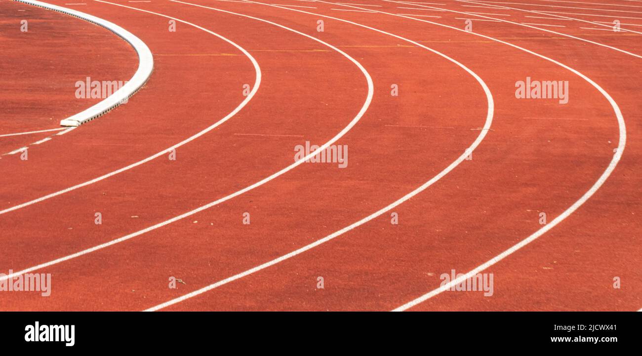 close up of a curved red athletics track in a sports facility Stock Photo