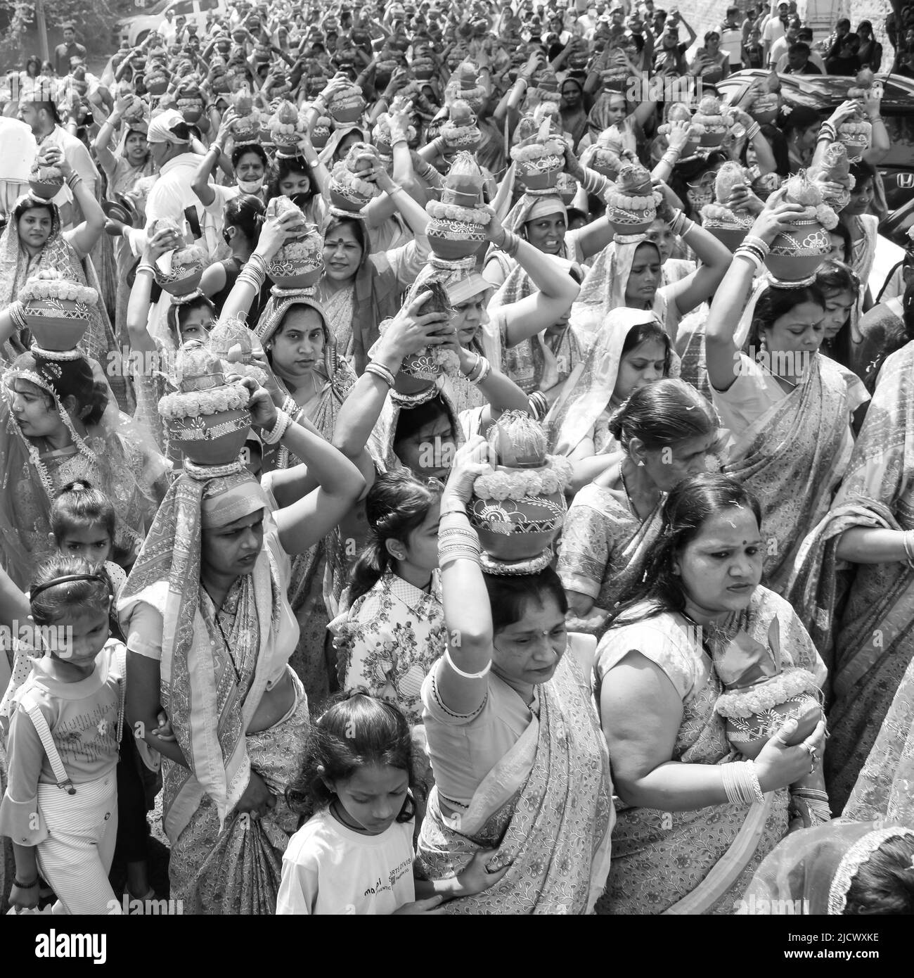 Delhi, India April 03 2022 - Women with Kalash on head during Jagannath Temple Mangal Kalash Yatra, Indian Hindu devotees carry earthen pots containin Stock Photo