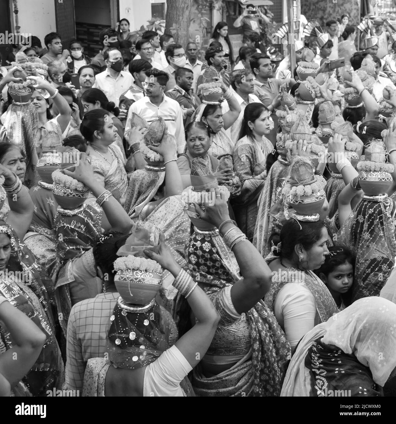 Delhi, India April 03 2022 - Women with Kalash on head during Jagannath Temple Mangal Kalash Yatra, Indian Hindu devotees carry earthen pots containin Stock Photo