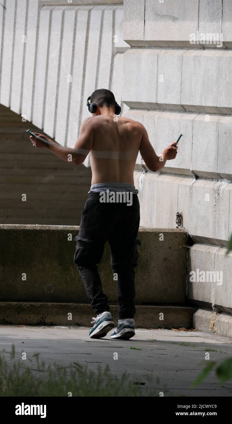 Young man exercising with skipping rope by Putney Bridge Stock Photo