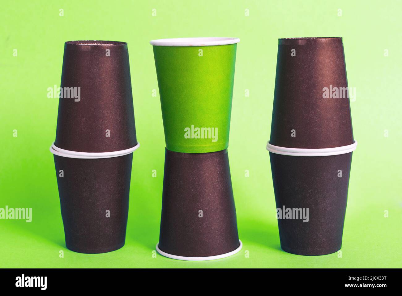 Eco-friendly disposable brown and green paper cups on a green ...