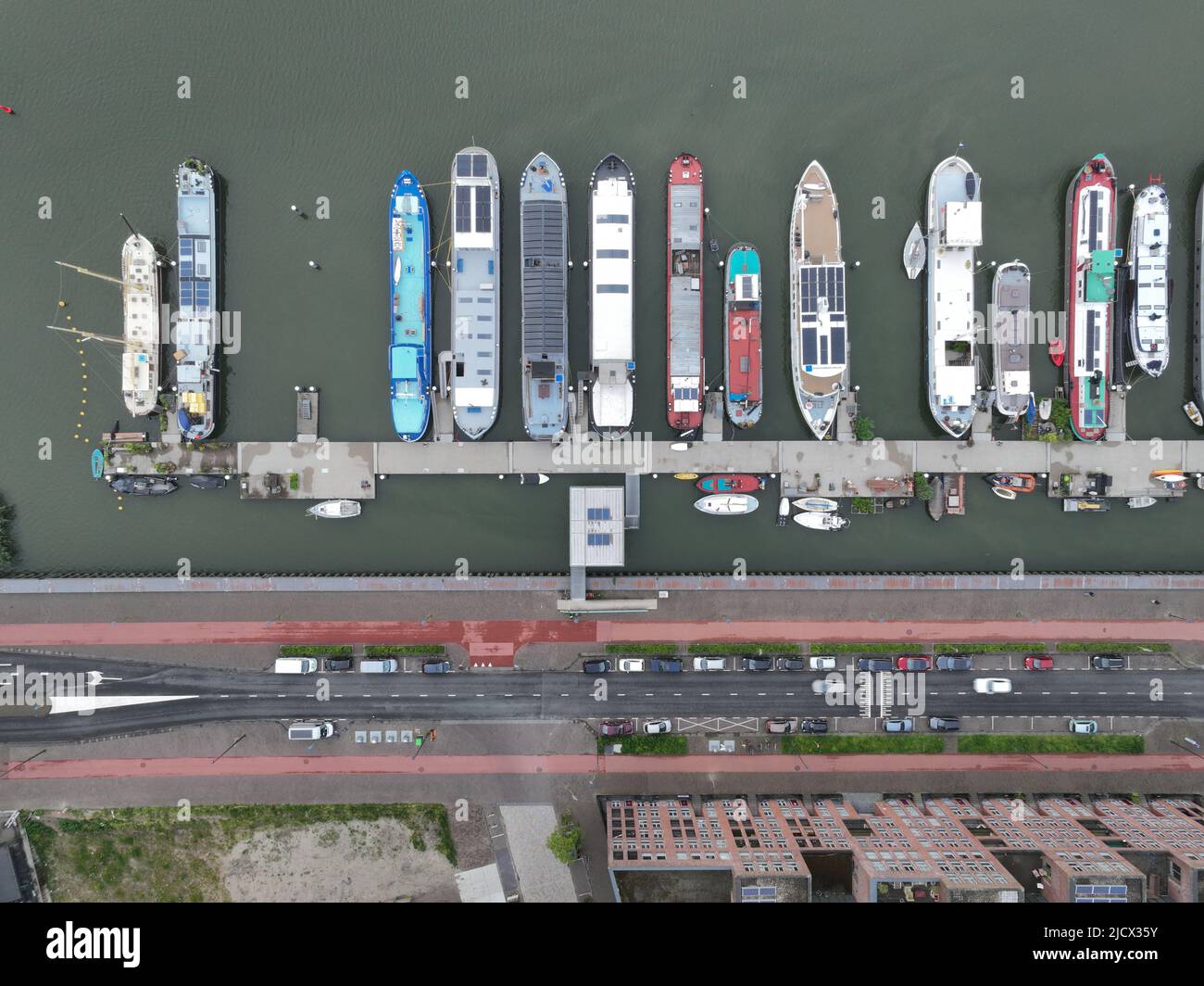 Inland vessel houseboat residential function living on a ark or ship housing pier dock village. Overhead aerial drone overview. Historical non movable Stock Photo