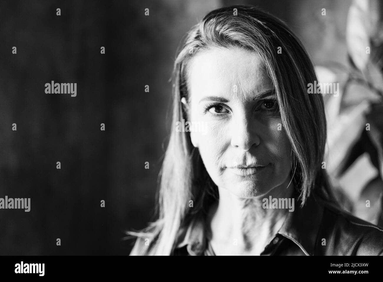 Senior business woman looking at camera - Focus on face - Black and white editing Stock Photo